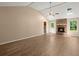 Bright living room with wood floors, brick fireplace, ceiling fan, and skylights at 8116 Long Shadow Ln, North Charleston, SC 29406