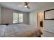 This inviting bedroom features modern ceiling fan, gray wood flooring, natural light, and neutral colors at 8483 Yadkin Cir # D, North Charleston, SC 29406