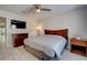 This inviting bedroom features modern ceiling fan, gray wood flooring, tv, lamp, and neutral colors at 8483 Yadkin Cir # D, North Charleston, SC 29406