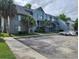 Condominium complex featuring reserved parking and mature landscaping at 8483 Yadkin Cir # D, North Charleston, SC 29406