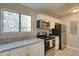 Galley kitchen with stainless steel appliances, granite countertops, and white cabinets at 8483 Yadkin Cir # D, North Charleston, SC 29406
