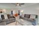 Inviting living room featuring modern sofas, stylish glass table, and a ceiling fan for ultimate comfort at 8483 Yadkin Cir # D, North Charleston, SC 29406