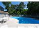 A serene community pool bordered by a fence and lush greenery, offering a refreshing escape at 8483 Yadkin Cir # D, North Charleston, SC 29406