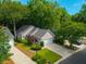 An aerial view of a well-maintained home with lush landscaping and a spacious driveway in a quiet neighborhood at 9175 Spring Branch Ct, North Charleston, SC 29406