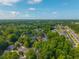 Scenic aerial view of a community with lush greenery and well-maintained homes under a blue sky at 9175 Spring Branch Ct, North Charleston, SC 29406