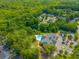 Aerial shot of community pool, clubhouse, and tennis courts nestled in lush green surroundings at 9175 Spring Branch Ct, North Charleston, SC 29406