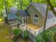 Backyard of house with deck, sunroom, mature trees, and pergola-covered patio at 9175 Spring Branch Ct, North Charleston, SC 29406