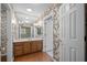 Bathroom with wallpaper, vanity, and chandelier lighting at 9175 Spring Branch Ct, North Charleston, SC 29406