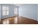 Light blue bedroom with hardwood floors, two windows with shutter and neutral trim at 9175 Spring Branch Ct, North Charleston, SC 29406