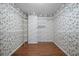 Spacious walk-in closet with ample wire shelving for storage and wood floors at 9175 Spring Branch Ct, North Charleston, SC 29406