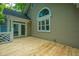 New wooden deck with white trim adjoins the house with convenient double-door access at 9175 Spring Branch Ct, North Charleston, SC 29406