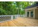 Spacious wooden deck with white railing provides an inviting transition between indoor and outdoor living spaces at 9175 Spring Branch Ct, North Charleston, SC 29406