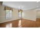 This dining room features hardwood floors, shuttered windows, and a chandelier at 9175 Spring Branch Ct, North Charleston, SC 29406