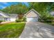 Well-maintained house featuring a lush green lawn, a driveway, and curb appeal at 9175 Spring Branch Ct, North Charleston, SC 29406