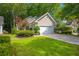 Charming single-Gathering home featuring a two-car garage, mature landscaping, and a well-manicured lawn at 9175 Spring Branch Ct, North Charleston, SC 29406
