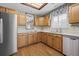 Kitchenette featuring oak cabinets, stainless steel appliances, and a mirror to reflect the light from the skylight at 9175 Spring Branch Ct, North Charleston, SC 29406