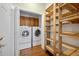 This space is equipped with a washer, dryer, and wooden shelves at 9175 Spring Branch Ct, North Charleston, SC 29406