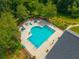 Overhead view of sparkling community pool featuring lounge chairs and beautiful landscaping at 9175 Spring Branch Ct, North Charleston, SC 29406
