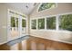 Sunroom features hardwood floors and sliding doors to the back deck at 9175 Spring Branch Ct, North Charleston, SC 29406