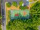 Overhead view of community tennis and pickleball courts surrounded by mature trees and parking at 9175 Spring Branch Ct, North Charleston, SC 29406