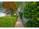 A paved walkway leading to the front entrance, lined with manicured bushes and vibrant foliage at 9175 Spring Branch Ct, North Charleston, SC 29406
