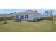 Exterior view of the home featuring a screened-in porch and a spacious, well-maintained backyard at 9700 Flooded Field Dr, Ladson, SC 29456