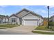 Well-maintained single Gathering home featuring a two-car garage, landscaped yard, and welcoming curb appeal at 9700 Flooded Field Dr, Ladson, SC 29456