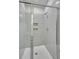 Modern bathroom shower featuring sleek glass doors, elegant herringbone tile, and convenient built-in niches at 0 Peirce Rd, Ridgeville, SC 29472