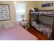Bedroom with bunk beds, a single bed, and beach-themed decor for a relaxing getaway at 1001 Palmetto Blvd, Edisto Island, SC 29438