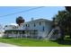 Charming raised home with a spacious balcony, fenced yard, and lush landscaping, offering beautiful outdoor space at 1001 Palmetto Blvd, Edisto Island, SC 29438