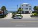 Charming coastal home with palm trees, covered parking, and beautiful beach access at 1001 Palmetto Blvd, Edisto Island, SC 29438
