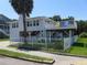 Inviting two-story home with a fenced yard and a charming balcony perfect for enjoying the coastal breeze at 1001 Palmetto Blvd, Edisto Island, SC 29438