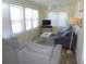 Comfortable living room with a ceiling fan and plenty of natural light from the large windows at 1001 Palmetto Blvd, Edisto Island, SC 29438