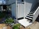Outdoor shower with adjacent stairs to the house, accented by beautiful flowers and a convenient design at 1001 Palmetto Blvd, Edisto Island, SC 29438