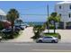 Parking area with palm trees and glimpses of the ocean, a convenient spot to park before hitting the beach at 1001 Palmetto Blvd, Edisto Island, SC 29438