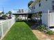 Well-maintained yard with lush grass, mature plants, and convenient access to the elevated deck and outdoor shower at 1001 Palmetto Blvd, Edisto Island, SC 29438