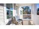 Inviting porch featuring comfortable seating, white railing, and views of surrounding trees at 1031 Riverbed Retreat Ln, Summerville, SC 29485