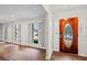 Inviting entryway showcasing hardwood floors, decorative front door with glass, and white plantation shutters at 1043 Dominion Dr, Hanahan, SC 29410