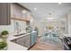 Modern eat-in kitchen featuring updated appliances, quartz counters, and stylish blue and gray cabinetry at 1043 Dominion Dr, Hanahan, SC 29410