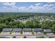 An aerial view showcasing well-maintained townhomes with ample parking and lush green surroundings at 1064 Lexi Ct, Ladson, SC 29456