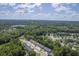 Expansive aerial view of a community featuring lush green trees, townhomes, and blue skies at 1064 Lexi Ct, Ladson, SC 29456