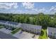 Aerial scene showing a variety of townhomes, with ample parking and green spaces at 1064 Lexi Ct, Ladson, SC 29456