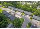 Neighborhood view showing townhomes, ample parking, lush trees and greenery at 1064 Lexi Ct, Ladson, SC 29456