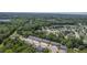Bird's-eye view of a community with tree lined streets, townhomes, and common parking at 1064 Lexi Ct, Ladson, SC 29456