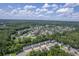 An aerial of a neighborhood with a pond and tree lined streets, showcasing community living at 1064 Lexi Ct, Ladson, SC 29456
