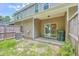 Backyard with sliding glass doors, patio, AC unit, wooden fence, and some greenery at 1064 Lexi Ct, Ladson, SC 29456