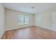 Cozy bedroom featuring wood-look flooring and large windows that offer ample natural light at 1064 Lexi Ct, Ladson, SC 29456