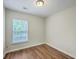 Well-lit bedroom with wood-look flooring and a window allowing for natural light and ventilation at 1064 Lexi Ct, Ladson, SC 29456
