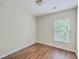Cozy bedroom featuring wood-look flooring and a window providing natural light and ventilation at 1064 Lexi Ct, Ladson, SC 29456