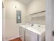 Laundry room featuring white washer and dryer, with a wire rack shelf for convenience at 1064 Lexi Ct, Ladson, SC 29456